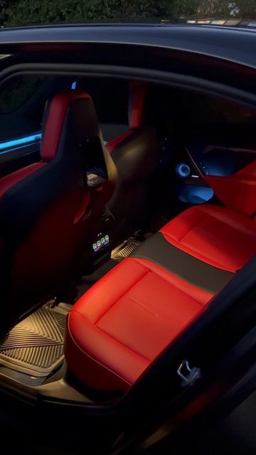 BMW M5 rear seats in red and black with rubber floor mats