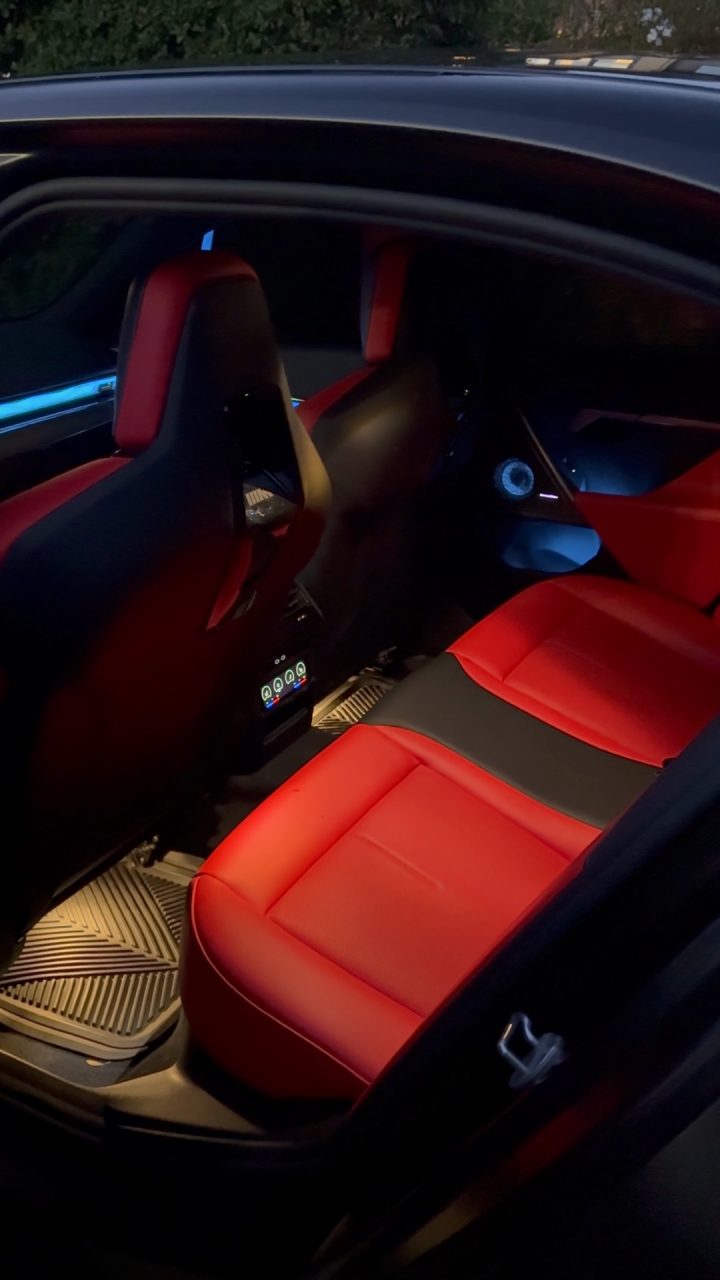 BMW M5 rear cabin with red and black seats and rubber floor mats